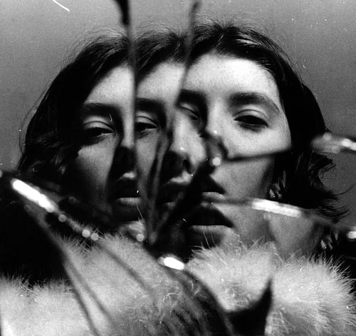 Person looking into a mirror as a symbol of self-reflection